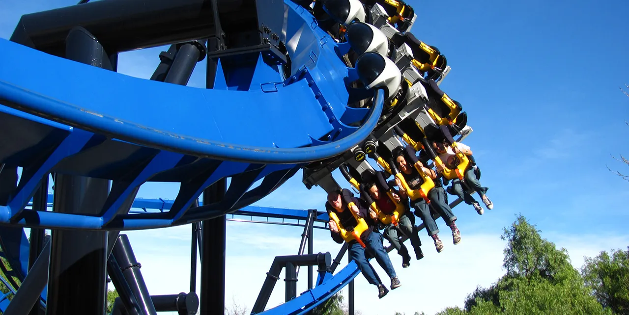 Six Flags roller coaster with riders experiencing thrills